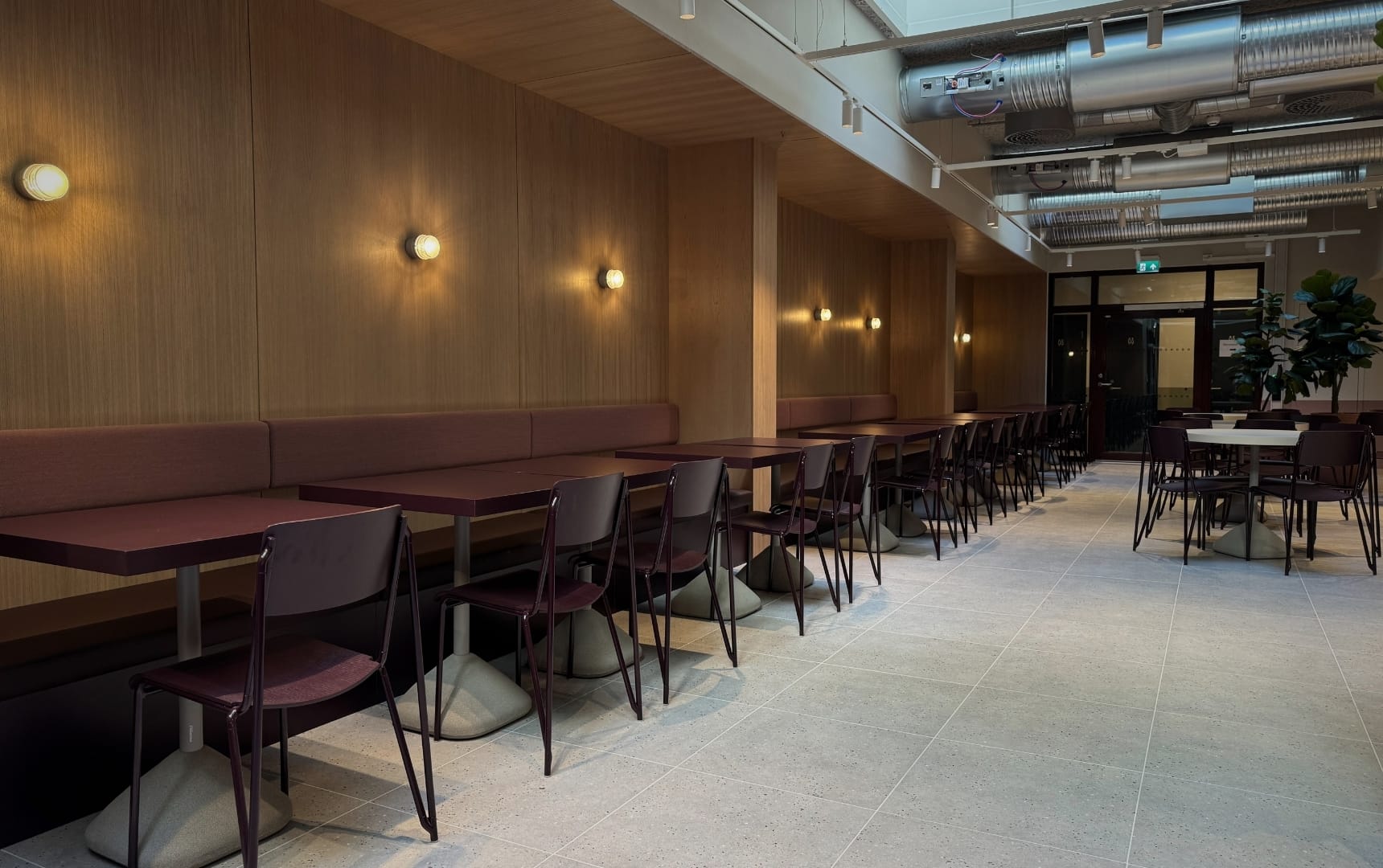 Wernergården innredning interiør og storkjøkken langsde kantine med modulsofa og bord og belysning