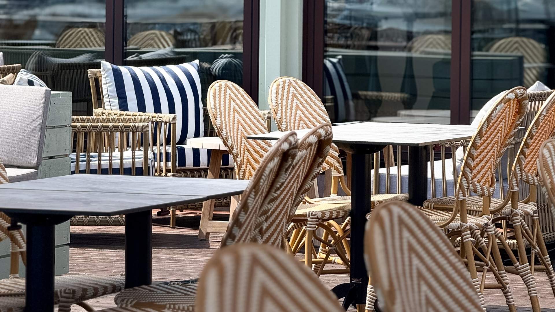 utemiljø ved uteservering utemøbler som stoler og bord ved havna hotell