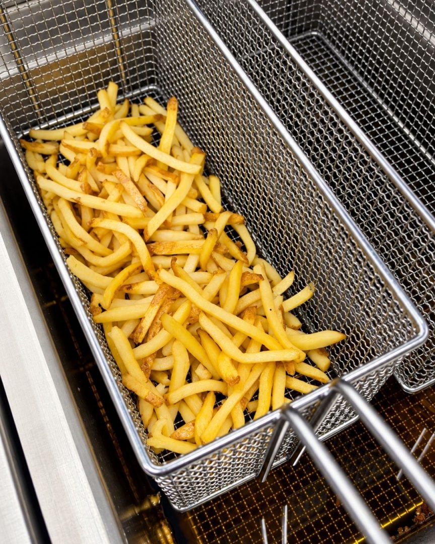 frityr med fries i olje på storkjøkken